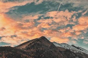 Stunning mountain landscape with vibrant sunset sky and snowy peaks. HD wallpaper