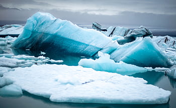 Majestic iceberg floating in Iceland's Jökulsárlón Glacier Lagoon, showcasing nature's beauty and fragility. HD wallpaper