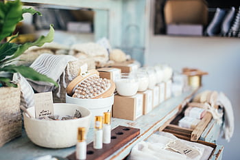 Relaxing spa essentials neatly displayed on a rustic wooden shelf, perfect for wellness and pampering. HD wallpaper