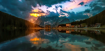 Dolomites, mirror, hills, beautiful, mountain, lake, darkness, reflection, clouds, sky, village, sunset HD wallpaper