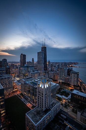 A breathtaking aerial shot of Chicago's skyline, featuring iconic skyscrapers at twilight, with views of Lake Michigan. HD phone wallpaper