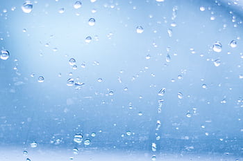Close-up of raindrops on a clear glass surface, creating a calm abstract pattern. HD wallpaper