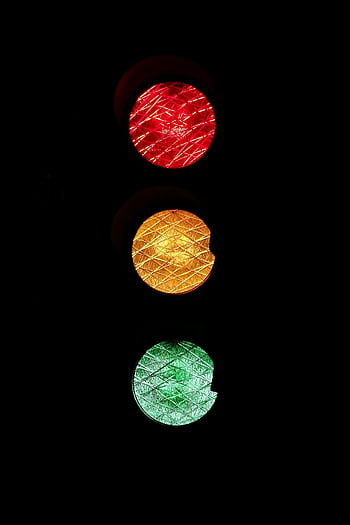 Vivid of red, yellow, and green traffic lights against a dark background. HD phone wallpaper