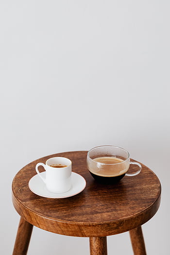 Two coffee cups on a wooden stool, showcasing minimalist style and warmth. HD phone wallpaper