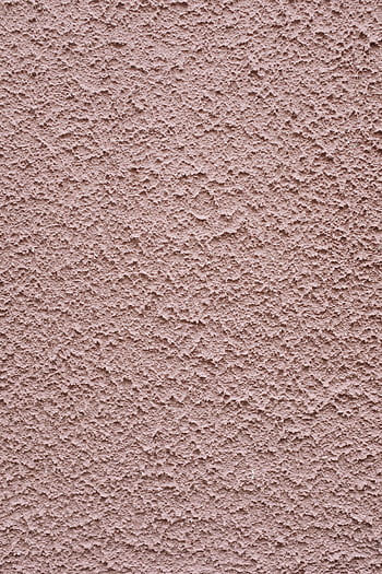 Close-up view of a textured pink concrete wall, perfect for backgrounds. HD phone wallpaper
