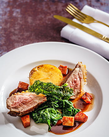 Savor a gourmet dish of roast lamb, crispy kale, and polenta, perfect for fine dining. HD phone wallpaper