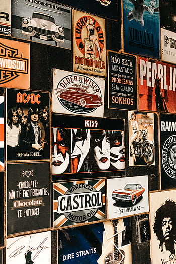 A collage of iconic rock band posters and vintage advertisements on a textured wall. HD phone wallpaper