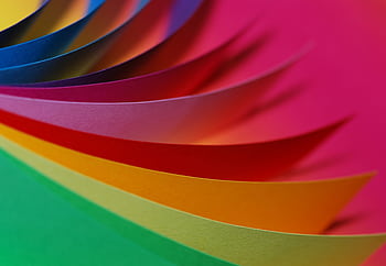 Vibrant layers of colorful paper arranged in a dynamic, abstract pattern. HD wallpaper