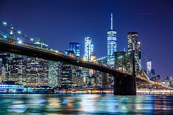 Stunning view of the Brooklyn Bridge and New York City skyline illuminated at night. HD wallpaper
