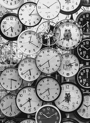 A black and white displaying a diverse array of vintage wall clocks. HD phone wallpaper