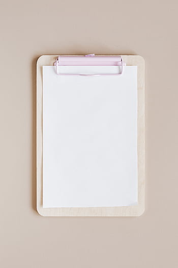Top view of a minimalist wooden clipboard with blank paper against a neutral background. HD phone wallpaper