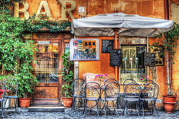 Vibrant outdoor café scene with colorful flowers and artistic details, perfect for urban exploration. HD wallpaper