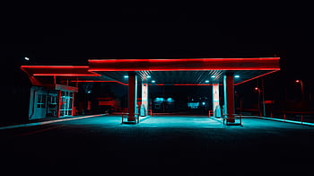 Urban gas station illuminated with vibrant neon lights at night. Modern transportation hub. HD wallpaper