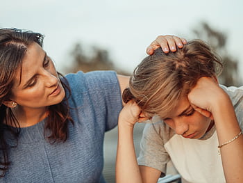 A mother offers support to her discouraged teenager son, portraying love and understanding. HD wallpaper