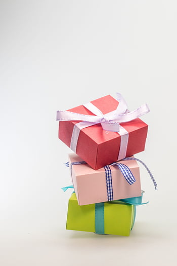 A stack of colorful gift boxes tied with ribbons, perfect for celebrations and festive occasions. HD phone wallpaper