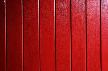 Vivid red wooden planks create a bold and rustic background. HD wallpaper