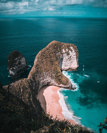 Breathtaking aerial shot of Kelingking Beach in Bali, showcasing turquoise waters and cliffs. HD phone wallpaper