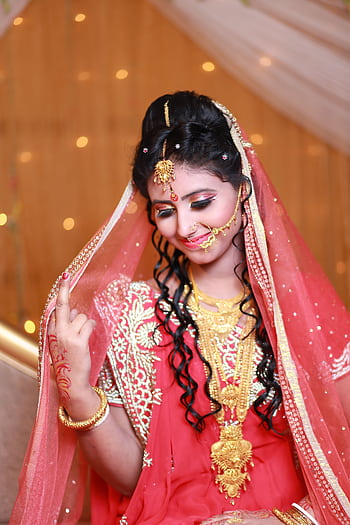 Beautiful Indian bride in traditional red saree and gold jewelry, exuding grace and elegance. HD phone wallpaper