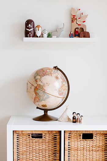 Cozy children's room with globe and toys, blending modern and vintage decor styles. HD phone wallpaper