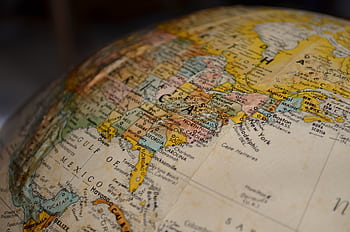 High-resolution close-up of North America on a vintage globe, showcasing detailed geographical features. HD wallpaper