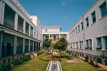 Elegant university building with garden courtyard in Rabat, Morocco under clear blue sky. HD wallpaper