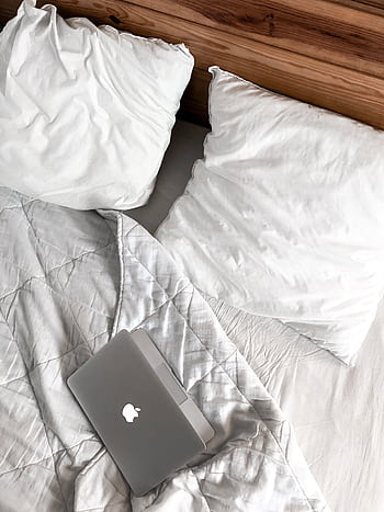 A comfortable bedroom scene with a laptop on a bed, perfect for remote work or relaxation. HD phone wallpaper