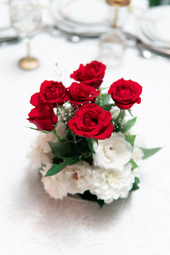 Elegant bouquet of red roses and white flowers on a table setting, perfect for weddings. HD phone wallpaper