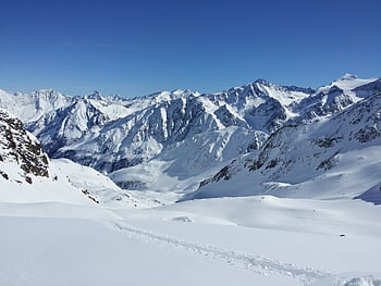 Majestic snowy mountains under a clear sky in Schwaz, Tirol, Austria. HD wallpaper
