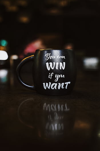 Black mug with inspirational quote 'You can win if you want' reflected on a dark surface, creating a motivational ambiance. HD phone wallpaper