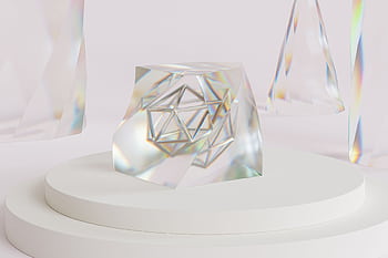 Futuristic geometric crystal art on a minimalist white podium. HD wallpaper