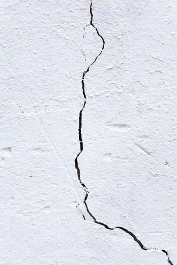 Close-up textured of a cracked white wall, ideal for background or design use. HD phone wallpaper