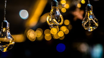 Artistic shot of hanging light bulbs with a beautiful bokeh background effect. HD wallpaper