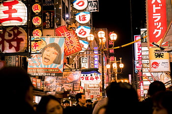 Explore the bustling nightlife of Osaka's Dotonbori street with vivid neon lights and bustling crowds. HD wallpaper