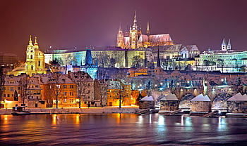 Illuminated Prague Castle and Vltava River at night in winter. Capturing historic beauty. HD wallpaper