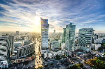 Breathtaking aerial view of Warsaw's modern skyline during sunset showcasing urban architecture. HD wallpaper