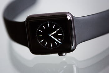 Close-up of an elegant black smartwatch with a minimalist classic dial on a light background. HD wallpaper