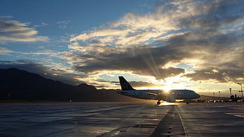 A beautiful silhouette of an airplane on a runway during a vibrant sunset at Čilipi Airport, Croatia. HD wallpaper