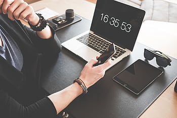 A modern workspace featuring a laptop, smart, tablet, and sunglasses, illustrating digital connectivity. HD wallpaper