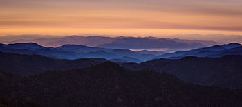 Beautiful panoramic view of mountains at sunrise with a colorful sky. HD wallpaper