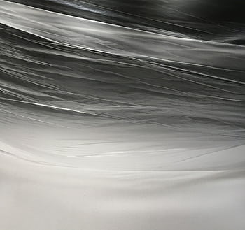 Mesmerizing abstract texture featuring layers of translucent plastic in monochrome tones. HD wallpaper