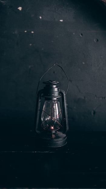 Moody close-up of an antique oil lantern against a grunge wall. Perfect for vintage themes. HD phone wallpaper