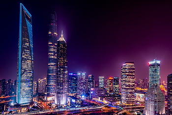 Majestic view of Shanghai's illuminated skyline featuring iconic skyscrapers at night. HD wallpaper