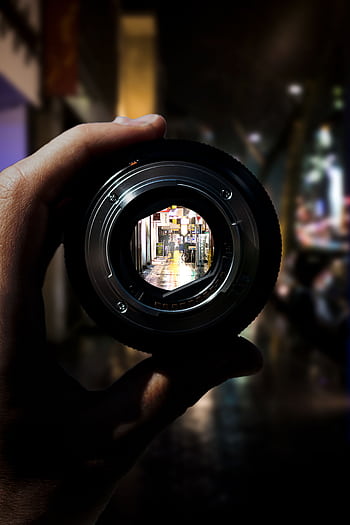 A unique perspective of Düsseldorf's city streets seen through a camera lens at night. HD phone wallpaper