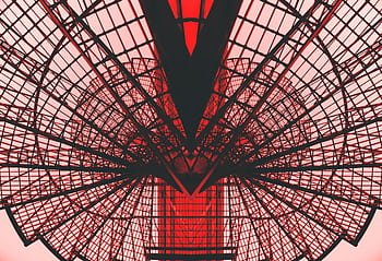 Abstract view of a red geometric architectural structure, showcasing modern design and symmetry. HD wallpaper