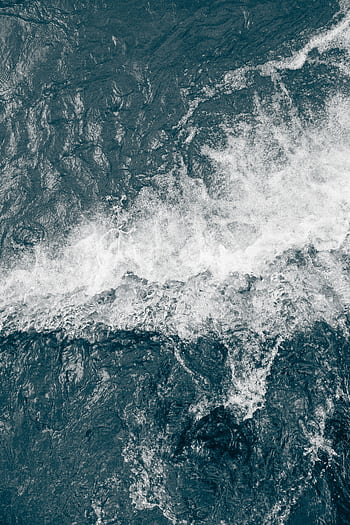 Aerial view of powerful ocean waves crashing, showcasing texture and motion. HD phone wallpaper