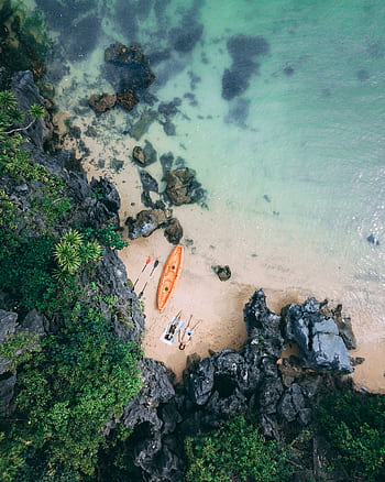 Captivating aerial shot of a serene beach with a kayak in Vietnam. HD phone wallpaper