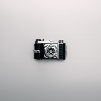 A classic Kodak camera displayed centrally on a minimalist white background. HD phone wallpaper