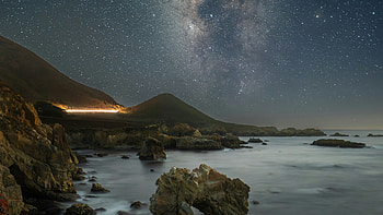 Milky Way Over The Silent Coast, sea, night, graphy, waves, way, island, highway, astronomy, hill, coast, cliff, traffic, light, arch, seascape, beach, land, scenery, lake, rock, nature HD wallpaper