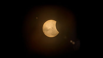 Captured partial solar eclipse set against a deep dark sky, perfect for astronomy enthusiasts. HD wallpaper