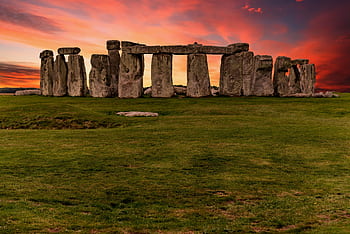 Capture of the iconic Stonehenge during a vibrant sunset with a dramatic sky. HD wallpaper